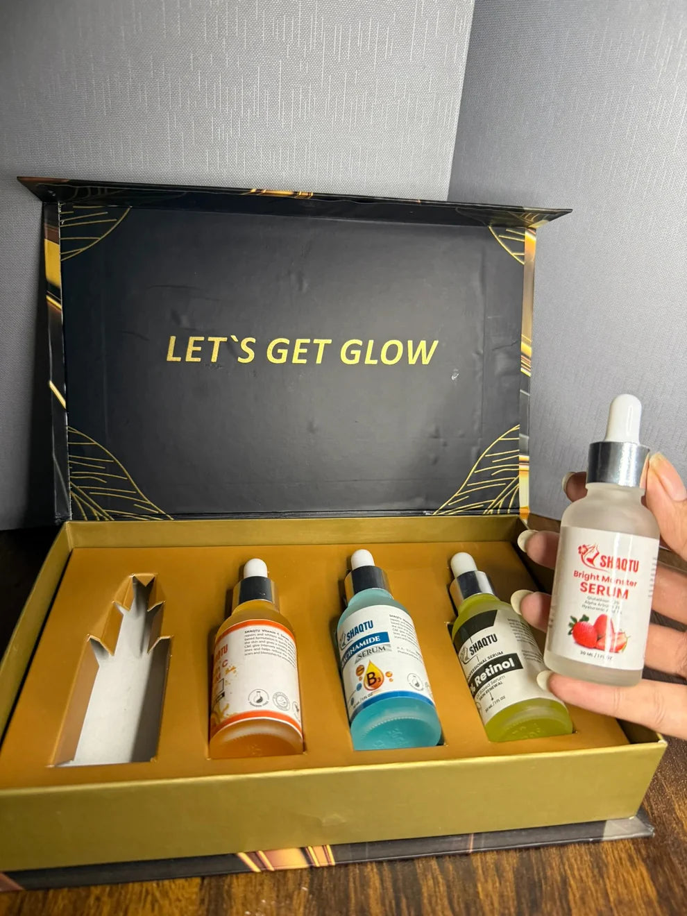 Complete Skin Transformation Kit 4 Professional Serums displayed in an elegant box with glowing text.
